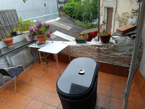 a chair sitting on top of a patio with plants at APARTAMENTO EDITA in Lugo