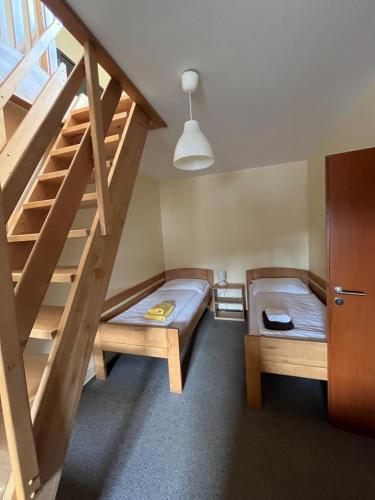 a room with two bunk beds and a staircase at Pension U Lyžaře in Jihlava