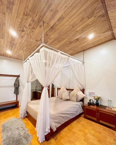 a bedroom with a bed with a canopy at Love House Homestay SAPA in Sa Pa