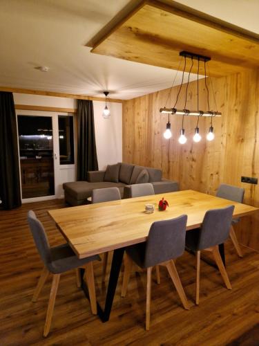 a dining room with a table and a couch at Haus Rätikon in Brand