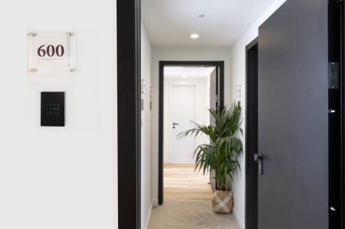 a hallway with a door and a potted plant at Hestia - Asklipiou 9 in Athens