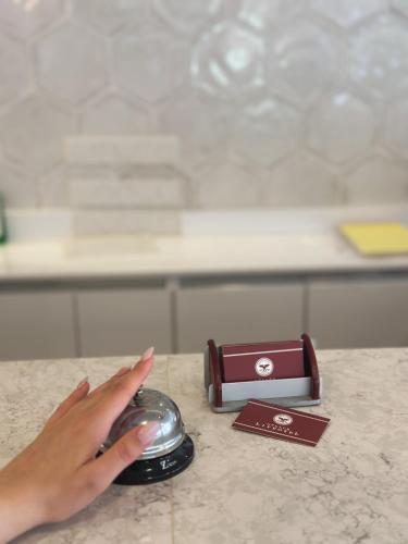 a hand is reaching for a mouse on a counter at Gulluk Life Hotel in Gulluk