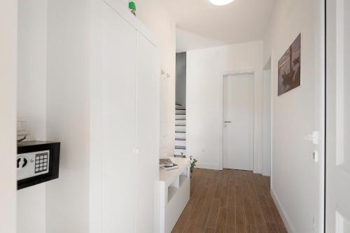 a room with a hallway with white walls and wooden floors at Papa's Court II Pasman Villa with pool in Pašman