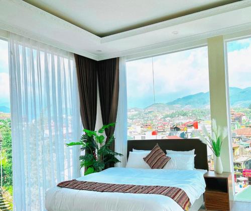 a bedroom with a bed in front of a large window at Love House Homestay SAPA in Sa Pa