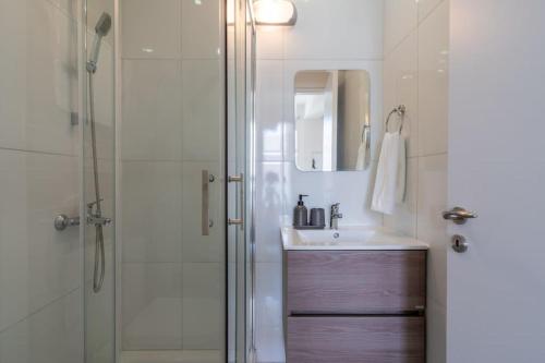 a bathroom with a sink and a shower at Stars 1-Bedroom Apartment in Larnaca in Larnaka