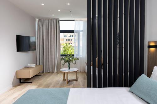 a hotel room with a bed and a window at Hestia - Asklipiou 9 in Athens