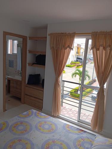 a bedroom with a sliding glass door with a balcony at Casa en curiti in Curití