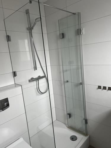 a bathroom with a glass shower with a toilet at Sleep & Go Motel in Unterbalbach