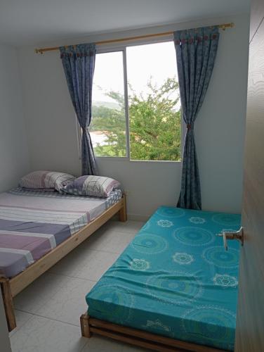 1 Schlafzimmer mit 2 Betten und einem Fenster in der Unterkunft Casa en curiti in Curití