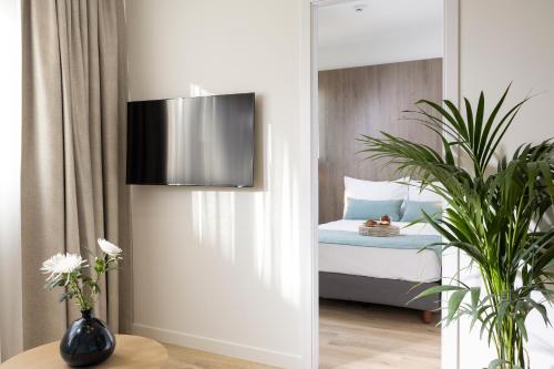a bedroom with a bed and a mirror at Hestia - Asklipiou 9 in Athens