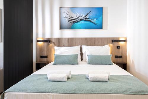 a bedroom with a large white bed with two pillows at Hestia - Asklipiou 9 in Athens