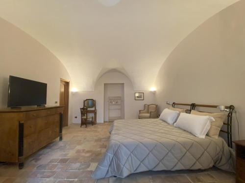 a bedroom with a bed and a flat screen tv at Il Giardinetto di Pettorano in Pettorano sul Gizio