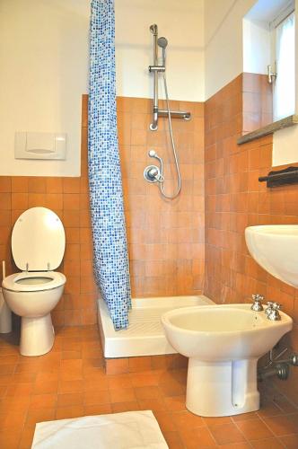 a bathroom with a shower and a toilet and a sink at Montecasciano - Tulipano in Capranica