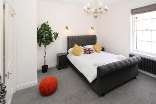 a small bedroom with a bed and a red ball at Chester City Centre Town House in Chester