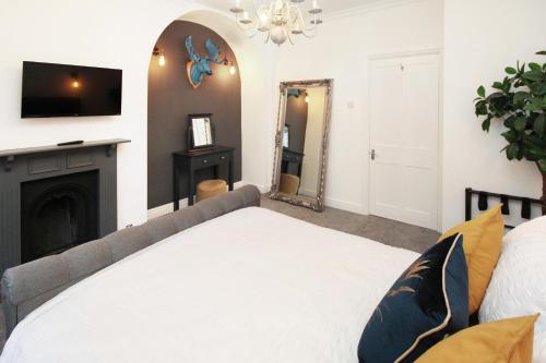 a bedroom with a bed and a fireplace at Chester City Centre Town House in Chester