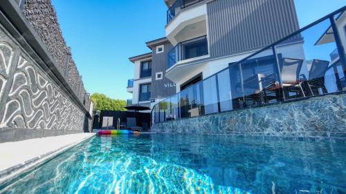 a swimming pool in front of a building at Serenity Villa in Dalaman