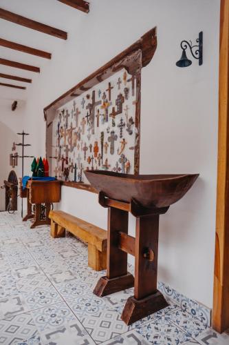 a room with a wooden table and a wall at Hotel Casa Alquimia in Quito