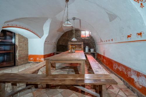 a room with two wooden tables in a building at Apartmány Pasáček in Nové Město na Moravě