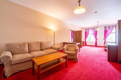 a living room with a couch and a table at Apartmány Pasáček in Nové Město na Moravě