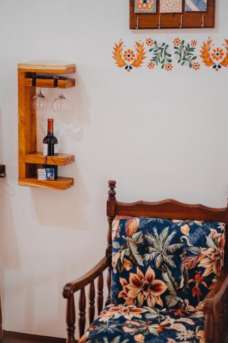 a chair with a floral pillow on a wall at Hotel Casa Alquimia in Quito