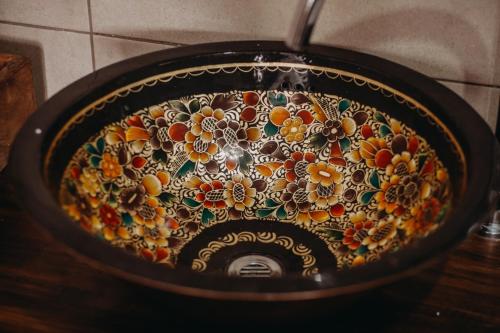 a bathroom sink with a flower pattern on it at Hotel Casa Alquimia in Quito