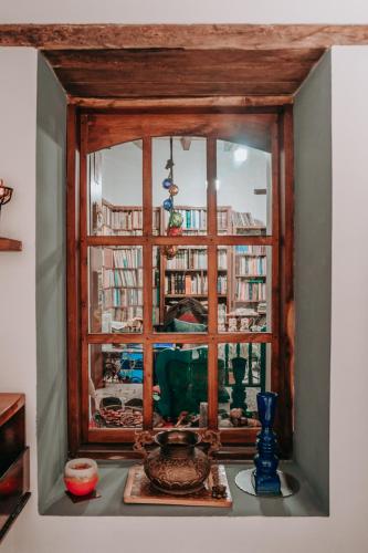 a window with a view of a room with books at Hotel Casa Alquimia in Quito