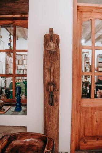 a room with a wooden door and a chair at Hotel Casa Alquimia in Quito
