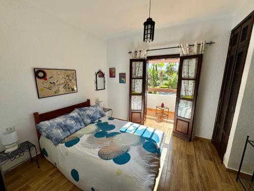 a bedroom with a bed and a door to a patio at Excelent Chalet Triplex in Kasr Rimal-Kabila Tetouan in M'diq