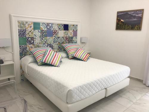 a bedroom with a bed with two pillows on it at Amalfi Suite Boutique Hotel in Amalfi