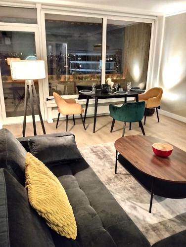 un salon avec un canapé et une table dans l'établissement large apartment 55 m² ,view & terrace Paris, à Paris