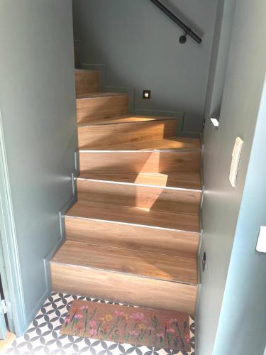 a staircase with wood treads in a house at L'Adresse - Rempart Sud - Eguisheim avec garage privé in Eguisheim