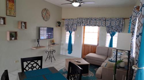 a living room with a couch and a table at Tropix Getaway - rental car available in Crocus Hill