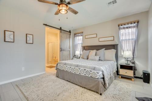 a bedroom with a bed and a ceiling fan at Lovely Tucson Home with Private Pool and Fire Pit! in Tucson