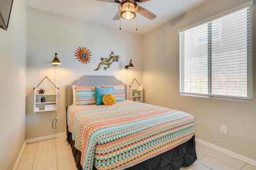 a bedroom with a bed and a ceiling fan at Lovely Tucson Home with Private Pool and Fire Pit! in Tucson
