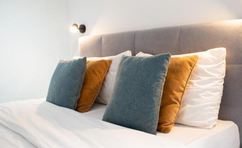 a group of pillows on top of a bed at Stylish 2 Bed 2 Bath Apt in St Julians in St. Julianʼs