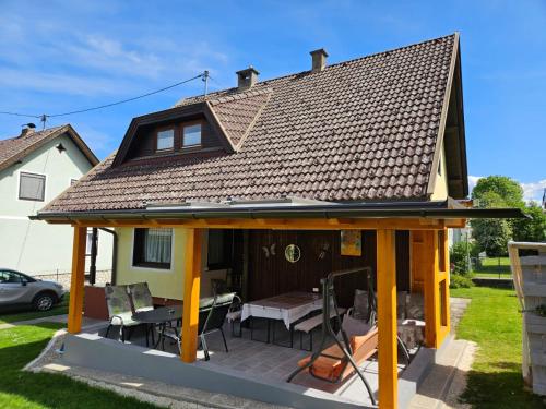 a gazebo with a roof on a house at Haus Erika in Völkermarkt