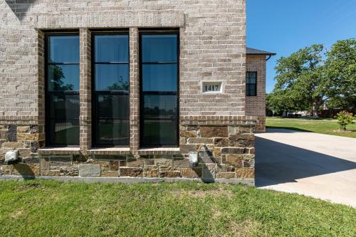 a brick building with large windows on it at Family Home Near Lake & Local Parks in Little Elm