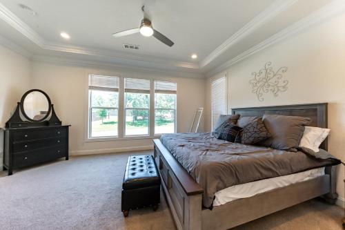 a bedroom with a bed and a mirror and a dresser at Family Home Near Lake & Local Parks in Little Elm