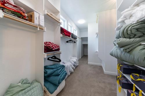 a walk in closet with a bunch of clothes at Family Home Near Lake & Local Parks in Little Elm