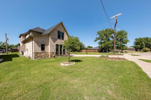 a house with a windmill in the yard at Family Home Near Lake & Local Parks in Little Elm