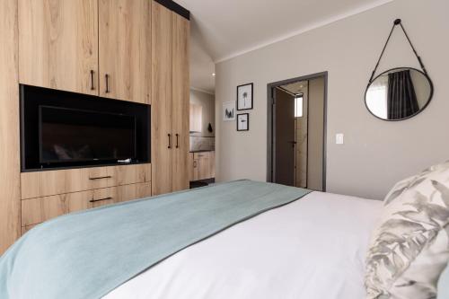 a bedroom with a large bed with a tv and a bed sqor at MINT Hotel 84 on Katherine in Johannesburg