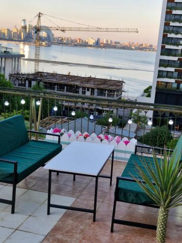 a patio with a table and chairs on a building at Nur Hotel & Terrace Cafe in Baku