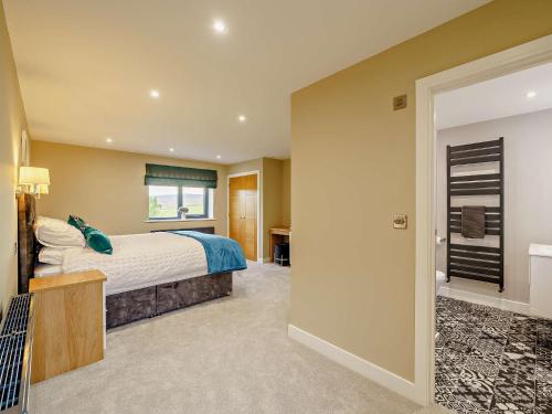 a bedroom with a large bed and a window at 4 Bed in Shap 89957 in Shap
