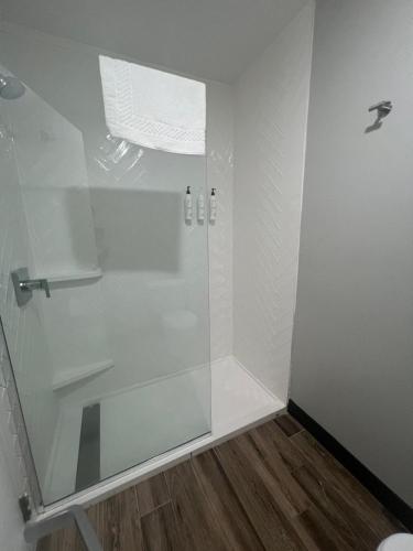 a shower with a glass door in a bathroom at TownePlace Suites Detroit Warren in Warren