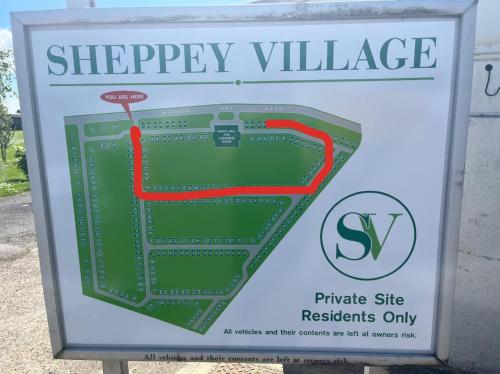a sign for a shopping village with a map at The Cosy Summer House in Leysdown-on-Sea