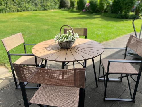 a table and chairs with a basket of flowers on it at Nordic Charme by B&B in Bad Gandersheim