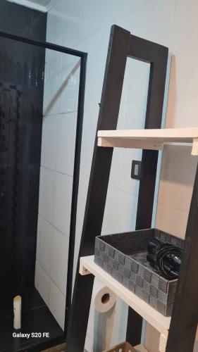 a bathroom with a shelf with a mirror and a sink at Cabañas en el campo in Navidad