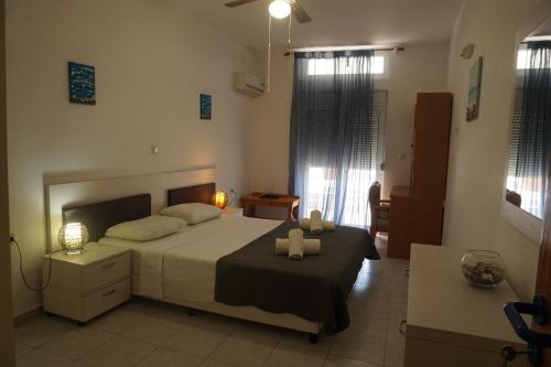a bedroom with a bed with two towels on it at Nicholas Waves Beach Studios in Lardos