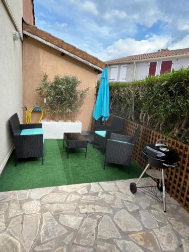 - une terrasse avec des chaises, un parasol et un grill dans l'établissement Maison T2 + cabine dans résidence avec piscine, à Marseillan