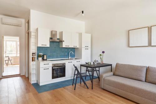 a kitchen and living room with a couch and a table at La Sismonda in Rimini
